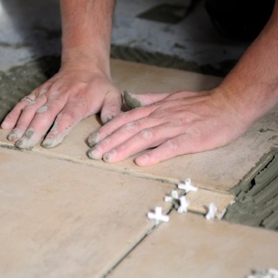 Installing ceramic floor tiles in your new Prrestige Kitchen